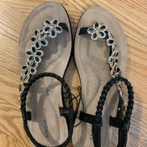 Black and Gold T-Strap Sandals with Floral Embellishments